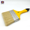 Yellow wooden handle bristle filament paintbrush for most of the paint