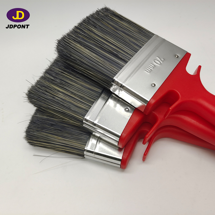 Paint brush with red plastic handle